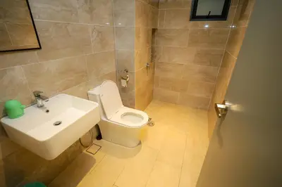 a bathroom with a white toilet and a sink at M Arisa Sentul by A&T in Kuala Lumpur