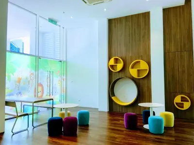 a room with a table and chairs and a mirror at Victoria Suites Quill Residence KLCC in Kuala Lumpur