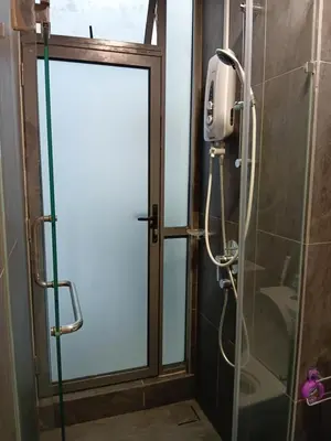 a shower with a glass door in a bathroom at Infinitum suites KLCC Sky Pool by EXA in Kuala Lumpur