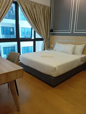 a bed in a room with a large window at Infinitum suites KLCC Sky Pool by EXA in Kuala Lumpur
