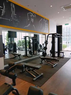 a gym with several tread machines and a large mirror at Infinitum suites KLCC Sky Pool by EXA in Kuala Lumpur