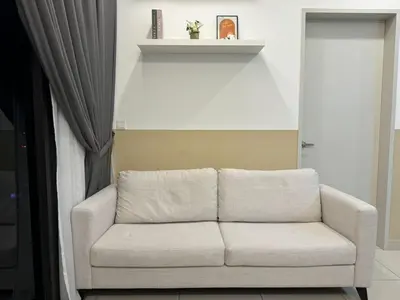 a white couch sitting in a room with a window at TRION KL, Jalan Chan Sow Lin, Kuala Lumpur in Kuala Lumpur