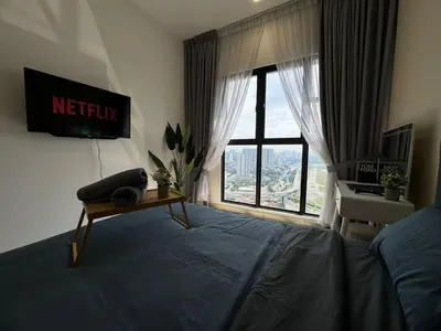 a bedroom with a bed with a television and a window at TRION KL, Jalan Chan Sow Lin, Kuala Lumpur in Kuala Lumpur