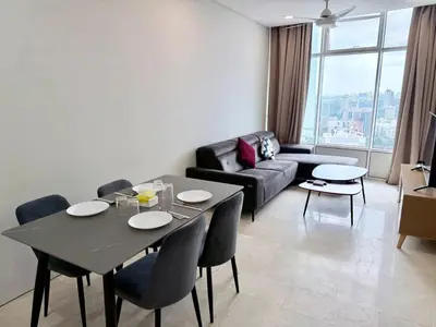 a living room with a table and a couch at Sky suites klcc by Aisyah in Kuala Lumpur