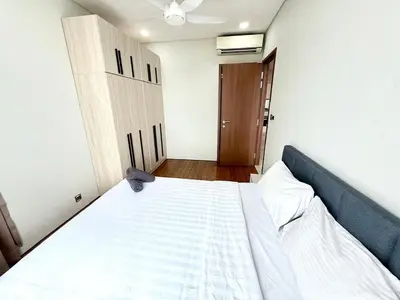 a bedroom with a large white bed and a door at Sky suites klcc by Aisyah in Kuala Lumpur