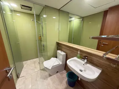 a bathroom with a sink and a shower and a toilet at Sky suites klcc by Aisyah in Kuala Lumpur