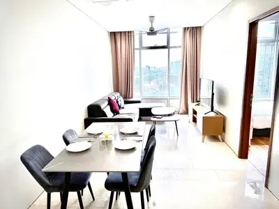 a dining room with a table and chairs and a couch at Sky suites klcc by Aisyah in Kuala Lumpur