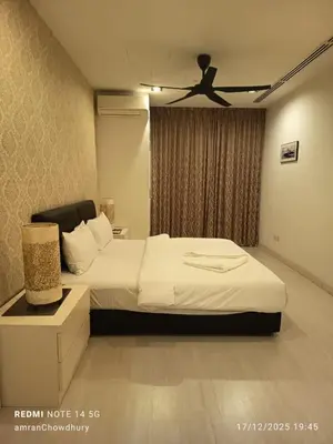 a bedroom with a bed and a ceiling fan at Binjai 8 KLCC BY Service Suites in Kuala Lumpur
