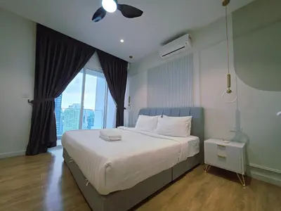 a bedroom with a large bed with a large window at Aurelia Suites Quill Residences in Kuala Lumpur