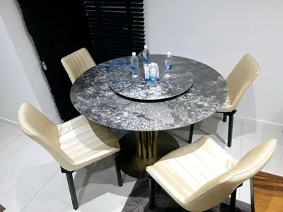 a dining room table with a marble table and chairs at Aurelia Suites Quill Residences in Kuala Lumpur