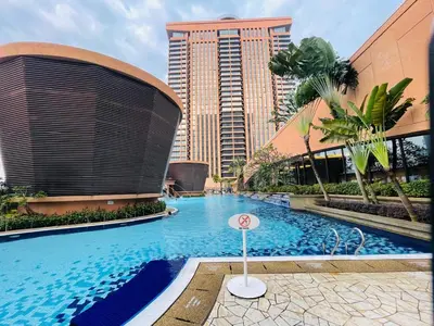 a large swimming pool in a city with tall buildings at Aurora Suites BUKIT At Times Square in Kuala Lumpur