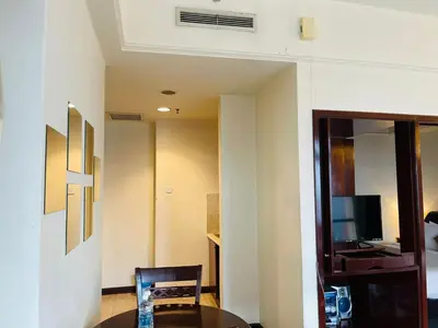 a room with a table and a chair and a television at Aurora Suites BUKIT At Times Square in Kuala Lumpur