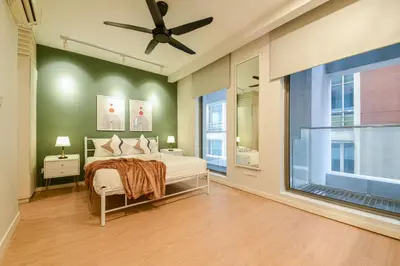 a bedroom with a bed and a large window at Fairlane Residence near Bukit Bintang KL in Kuala Lumpur