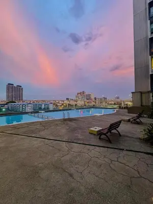 a view of a pool in a city at sunset at TikiiBunk Packers in Kuala Lumpur