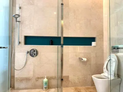a bathroom with a shower with a toilet and a glass door at Tropicana Residences CoolStay in Kuala Lumpur
