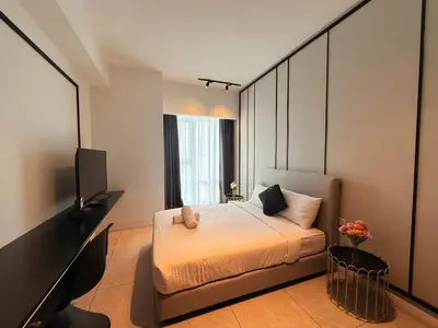 a bedroom with a bed and a flat screen tv at Axon Residence KL Luxury Bukit Bintang in Kuala Lumpur