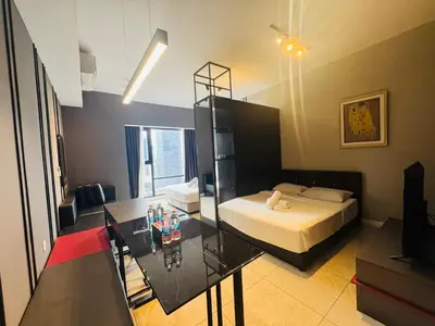 a bedroom with a bed and a glass table at Axon Residence KL Luxury Bukit Bintang in Kuala Lumpur