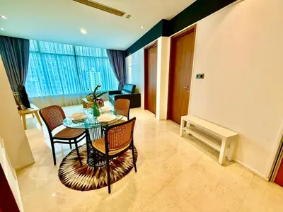 a dining room with a table and chairs in a room at Klcc vortex suites by comfort stay in Kuala Lumpur