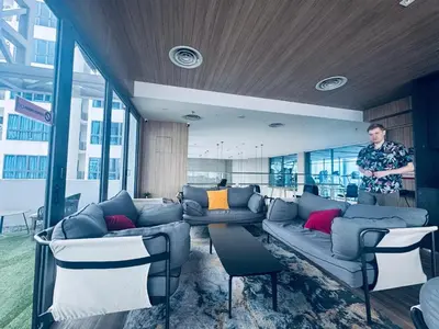 a man standing in a living room with a couch at The luxe klcc by jaurami stay in Kuala Lumpur
