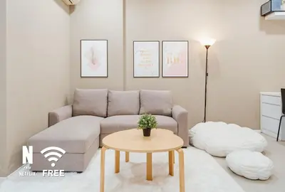 a living room with a couch and a table at Arcoris SOHO Mont Kiara , Stylish 1 Bedroom Retreat in Kuala Lumpur