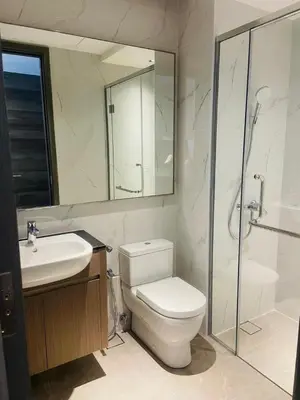 a bathroom with a toilet and a sink and a shower at Bukit Bintang Suites KLCC by YBS in Kuala Lumpur
