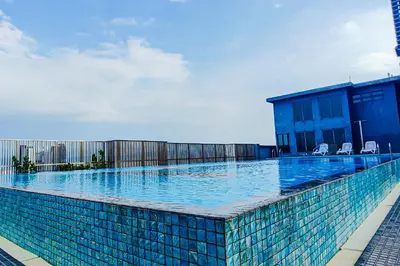 a swimming pool with chairs on a building at Sky Pool at 3 Towers Ampang by HCK in Kuala Lumpur