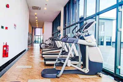 a row of tread machines in a gym at Sky Pool at 3 Towers Ampang by HCK in Kuala Lumpur