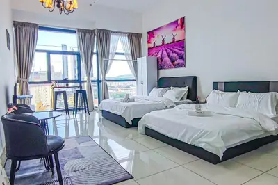 a bedroom with two beds and a table and chairs at Sky Pool at 3 Towers Ampang by HCK in Kuala Lumpur