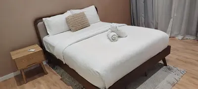 a bed with two stuffed animals on top of it at Queen Suites at Quill Residence KL in Kuala Lumpur