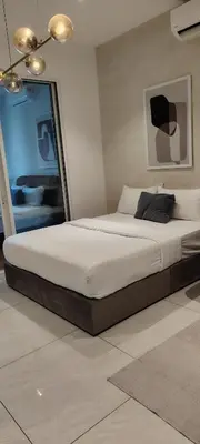a bedroom with a large bed in a room at Queen Suites at Quill Residence KL in Kuala Lumpur