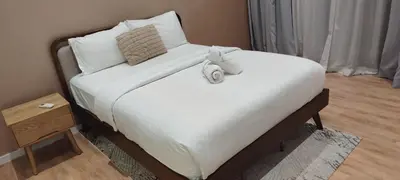 a bed with two stuffed animals on top of it at Queen Suites at Quill Residence KL in Kuala Lumpur