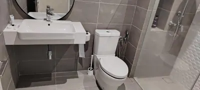 a bathroom with a white toilet and a sink at Queen Suites at Quill Residence KL in Kuala Lumpur