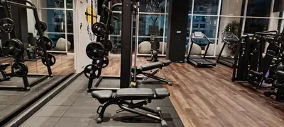 a gym with rows of tread machines in a building at Queen Suites at Quill Residence KL in Kuala Lumpur