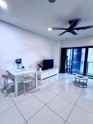 a living room with a table and a ceiling fan at Mercu Summer Suites KLCC by Jk Privy Homes - Entire Studio in Kuala Lumpur