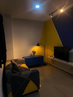 a living room with a couch and a tv at 10 Mins to KLCC Cozy Place to Stay in Kuala Lumpur