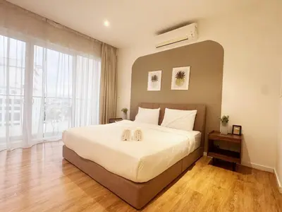 a bedroom with a large bed and a large window at Veone Hotel Kuala Lumpur in Kuala Lumpur