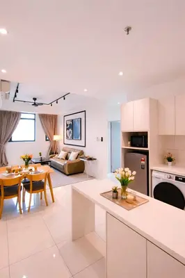a kitchen and living room with a table and a couch at Future Star Chamber Residence in Kuala Lumpur