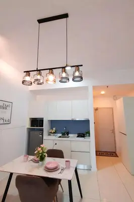 a kitchen and dining room with a table and a chandelier at Future Star Chamber Residence in Kuala Lumpur
