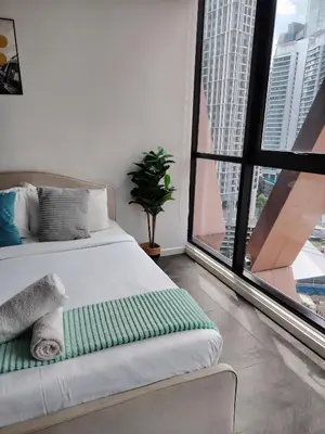 a bedroom with a bed and a large window at The Times Square KLCC by Bukit Bintang in Kuala Lumpur