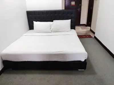 a bed with white sheets and pillows in a room at The Times Square KLCC by Bukit Bintang in Kuala Lumpur