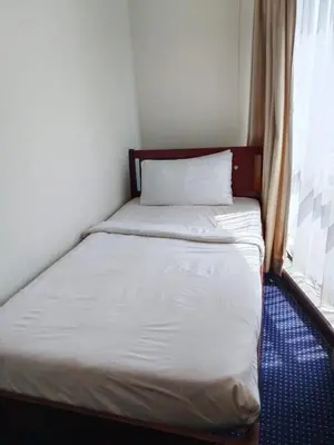 a small bed in a room with a window at The Times Square KLCC by Bukit Bintang in Kuala Lumpur