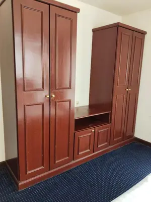 a large wooden cabinet in a room at The Times Square KLCC by Bukit Bintang in Kuala Lumpur