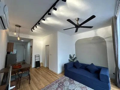 a living room with a blue couch and a ceiling fan at Staycay Majestic Residence KL in Kuala Lumpur