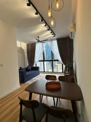 a living room with a table and chairs and a couch at Staycay Majestic Residence KL in Kuala Lumpur