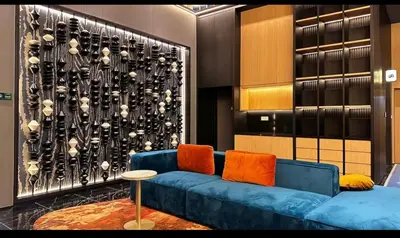 a living room with a blue couch and a wall at Staycay Majestic Residence KL in Kuala Lumpur