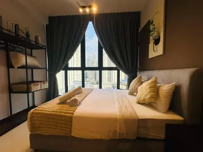a bedroom with a bed with a large window at LA Majestic Suites at KlCC in Kuala Lumpur