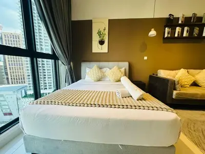 a bedroom with a large bed and a couch at LA Majestic Suites at KlCC in Kuala Lumpur