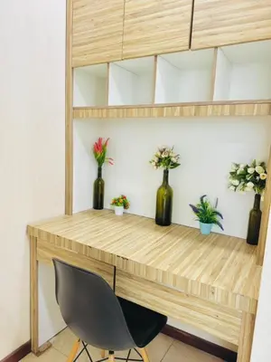 a wooden desk with vases with flowers in it at Apartment Kuala Lumpur City 3 Minutes To KLCC in Kuala Lumpur