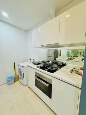 a white kitchen with a stove and a dishwasher at Apartment Kuala Lumpur City 3 Minutes To KLCC in Kuala Lumpur