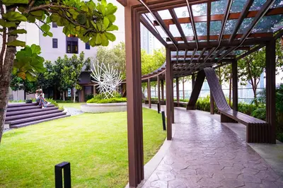 a wooden pergola in a park with a grass field at Axon Residences KLCC - CR Homestay in Kuala Lumpur